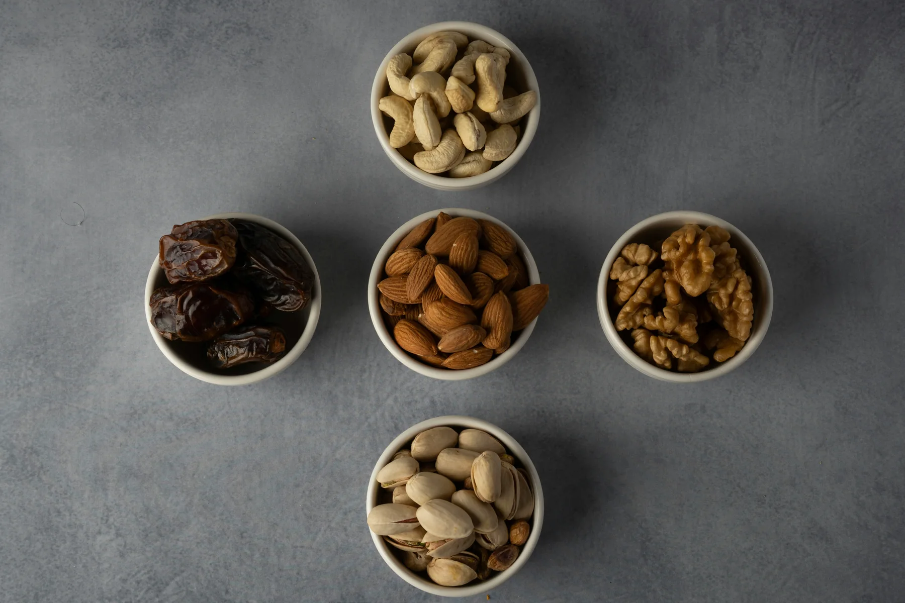 Assorted nuts and dates in bowls